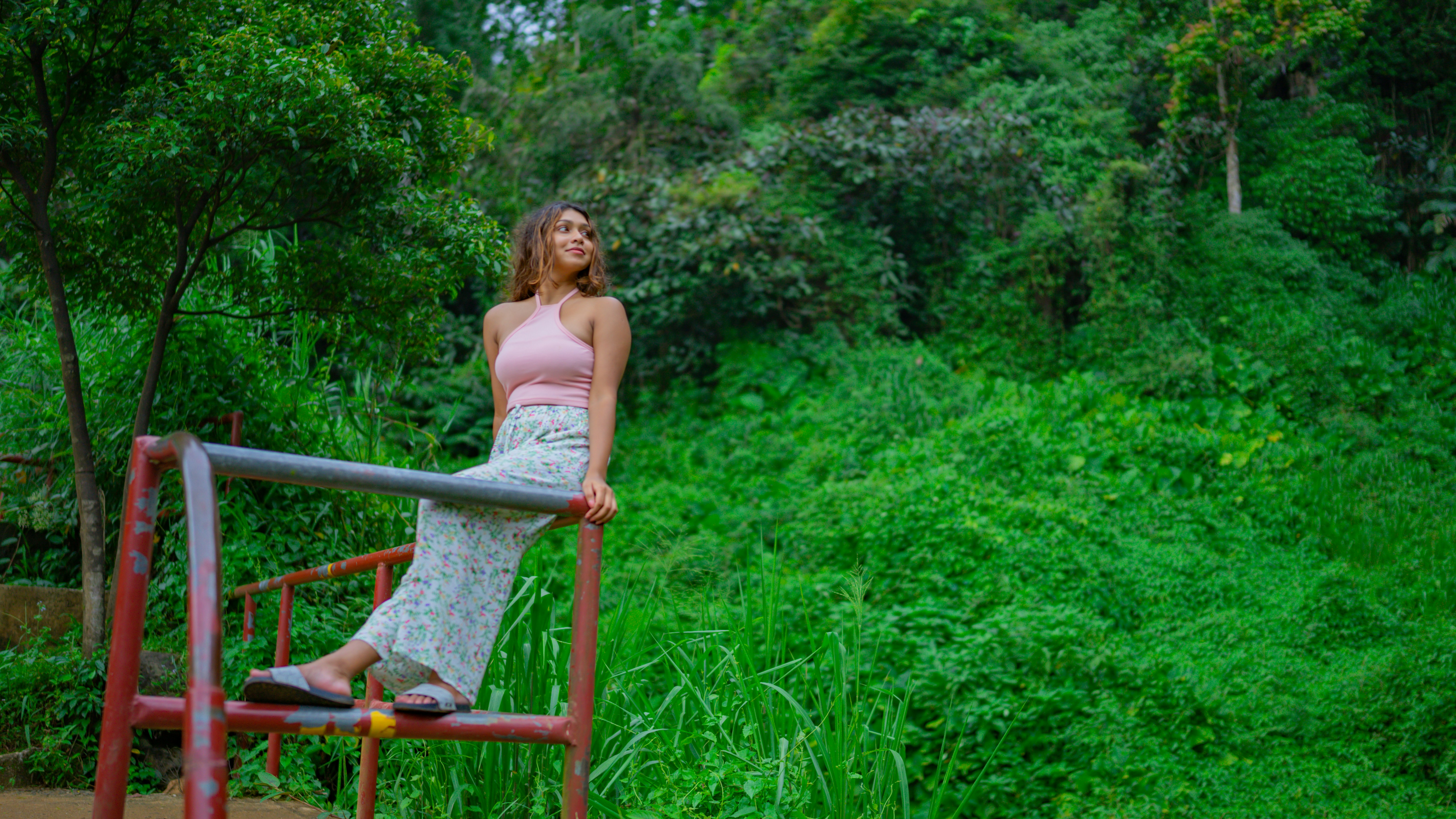 a woman is standing on a red railing