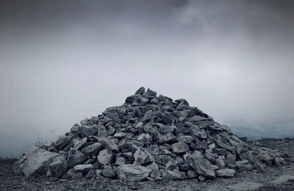 a pile of rocks sitting on top of a dirt field