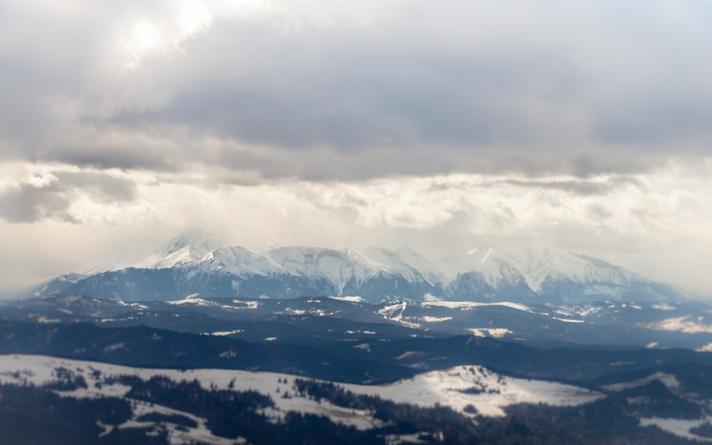 a view of a snowy mountain range from an airplane