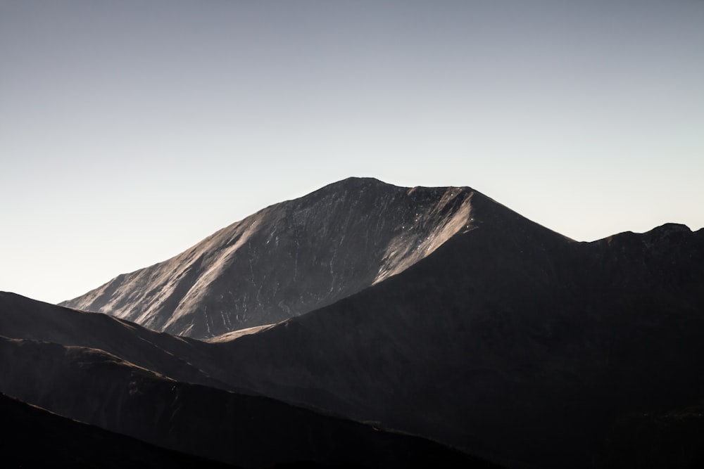 a view of a mountain with a sky in the background