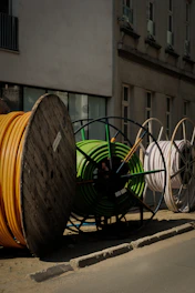 a pile of yellow and green hoses sitting on the side of a road