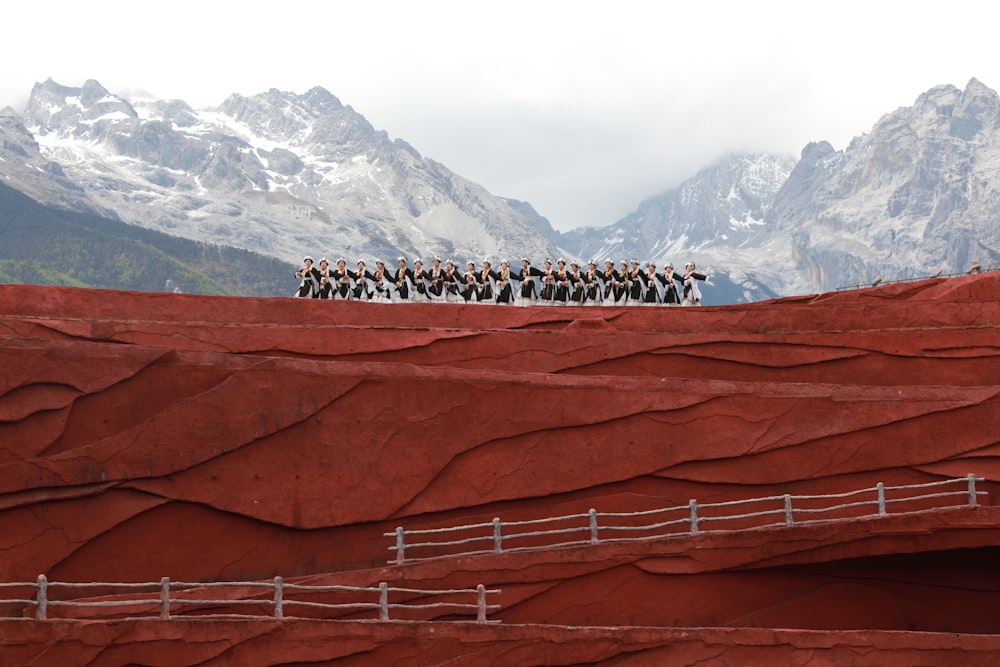 a group of people standing on top of a mountain