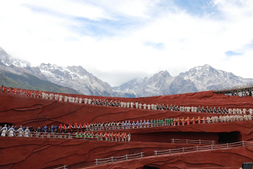 A group of local candidates from Ensemble smiling warmly in front of the alpine landscape of Glières-Val-de-Borne.