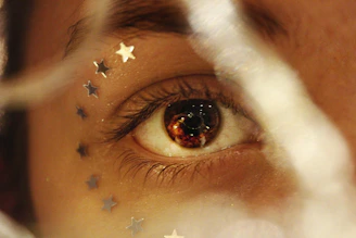 Close-up of a human eye reflecting a cosmic starfield, symbolizing universal connection.