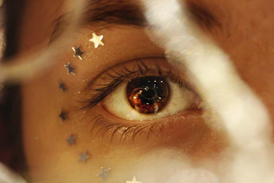 Close-up of a human eye reflecting a cosmic starfield, symbolizing universal connection.