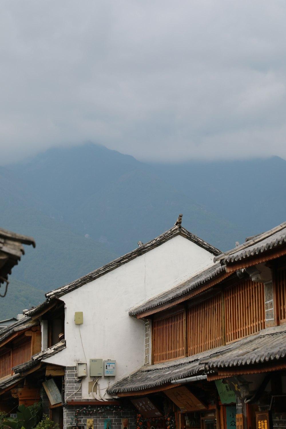 a row of buildings with mountains in the background