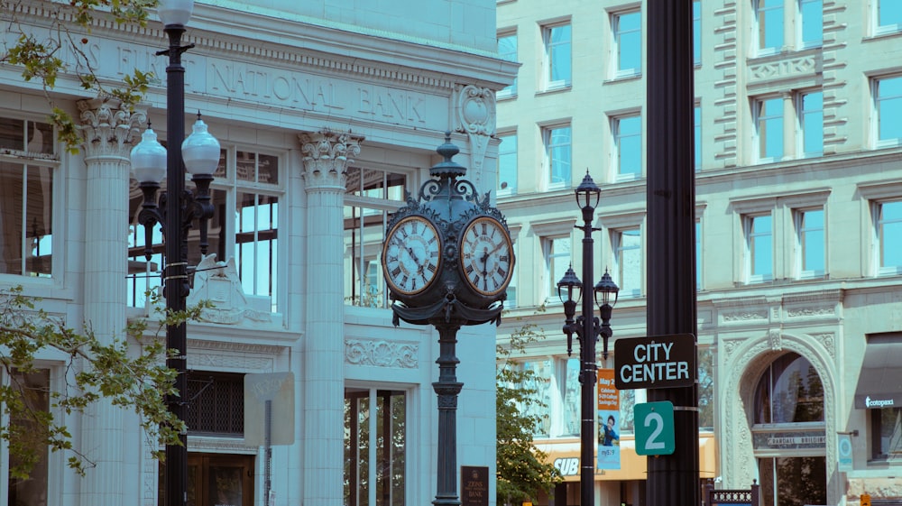 a clock on a pole on a city street