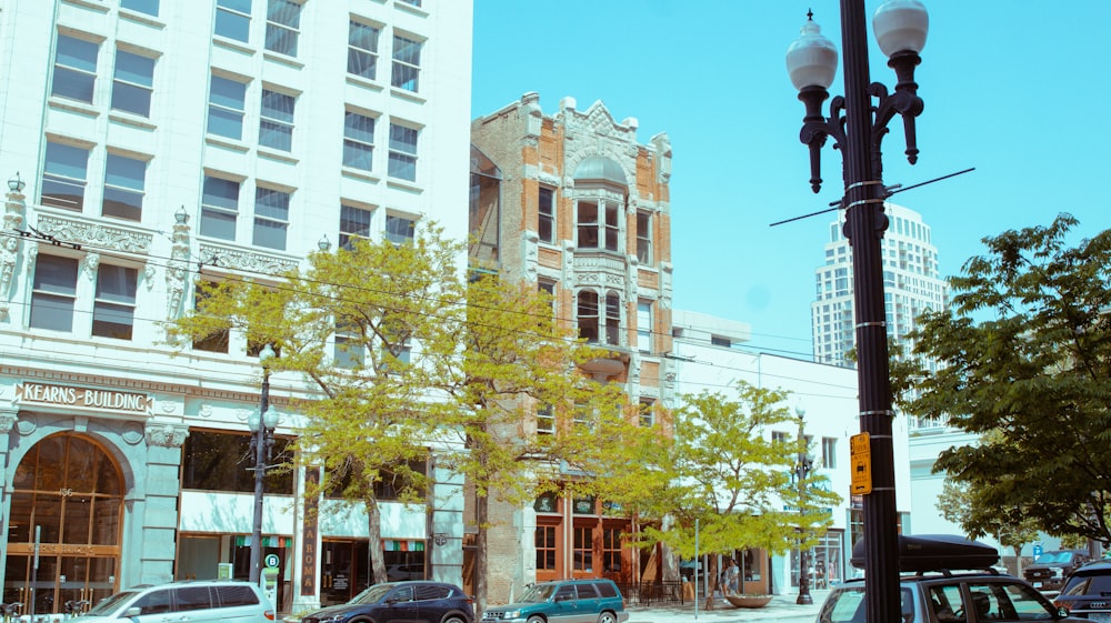 a city street filled with traffic next to tall buildings