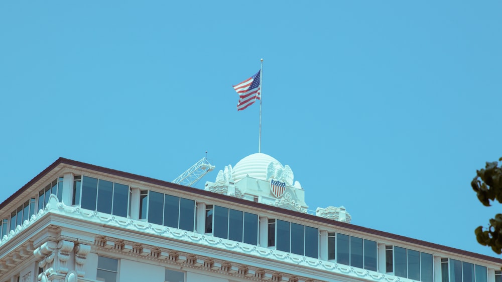 an american flag flying on top of a building