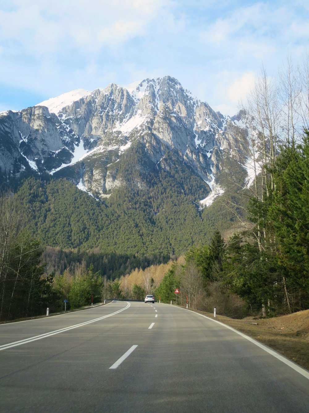 a road with a mountain in the background