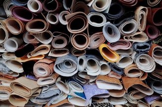 a pile of different types of shoes are stacked on top of each other