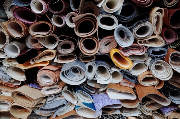 a pile of different types of shoes are stacked on top of each other