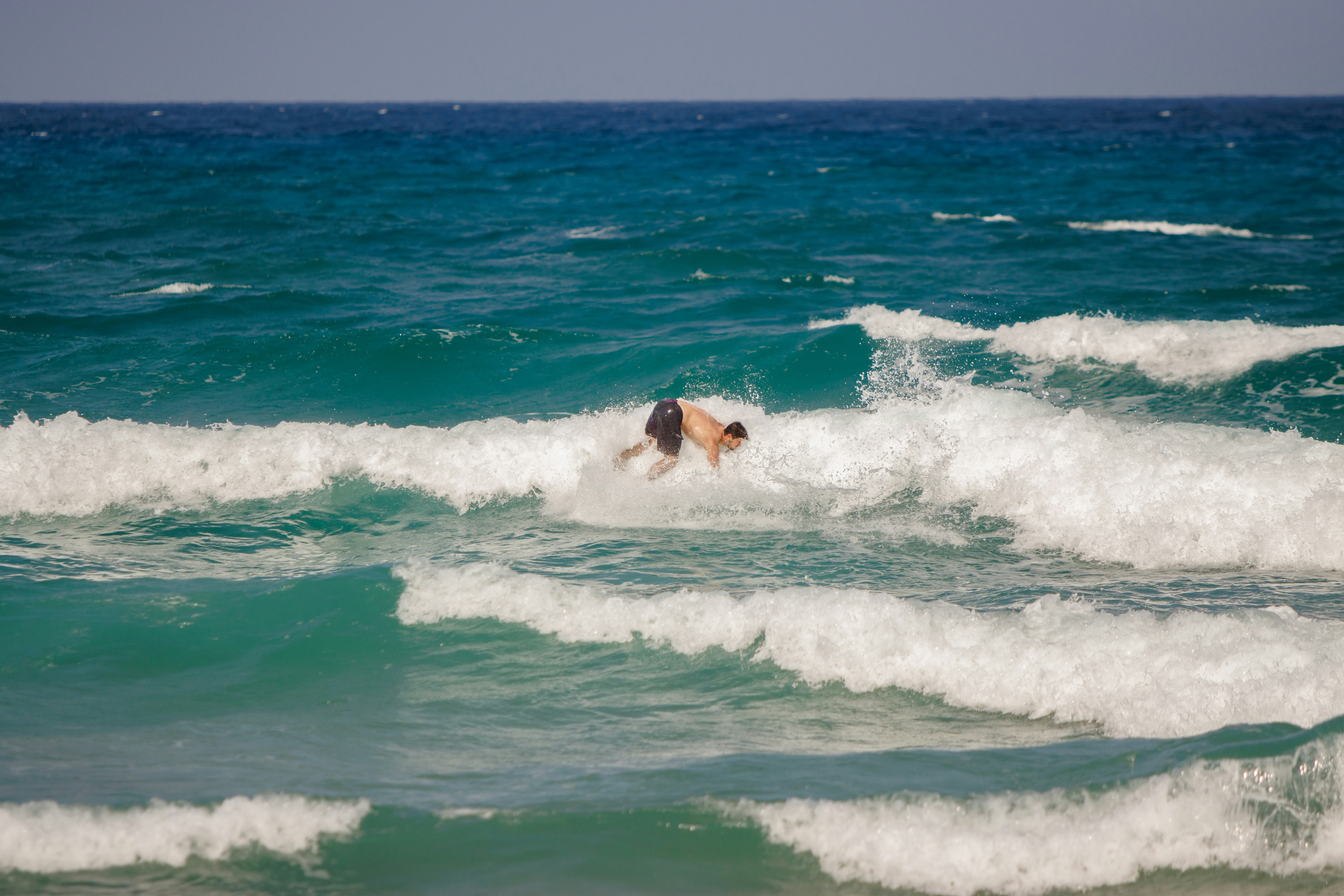 A man riding a wave on top of a surfboard photo – Free Person Image on ...