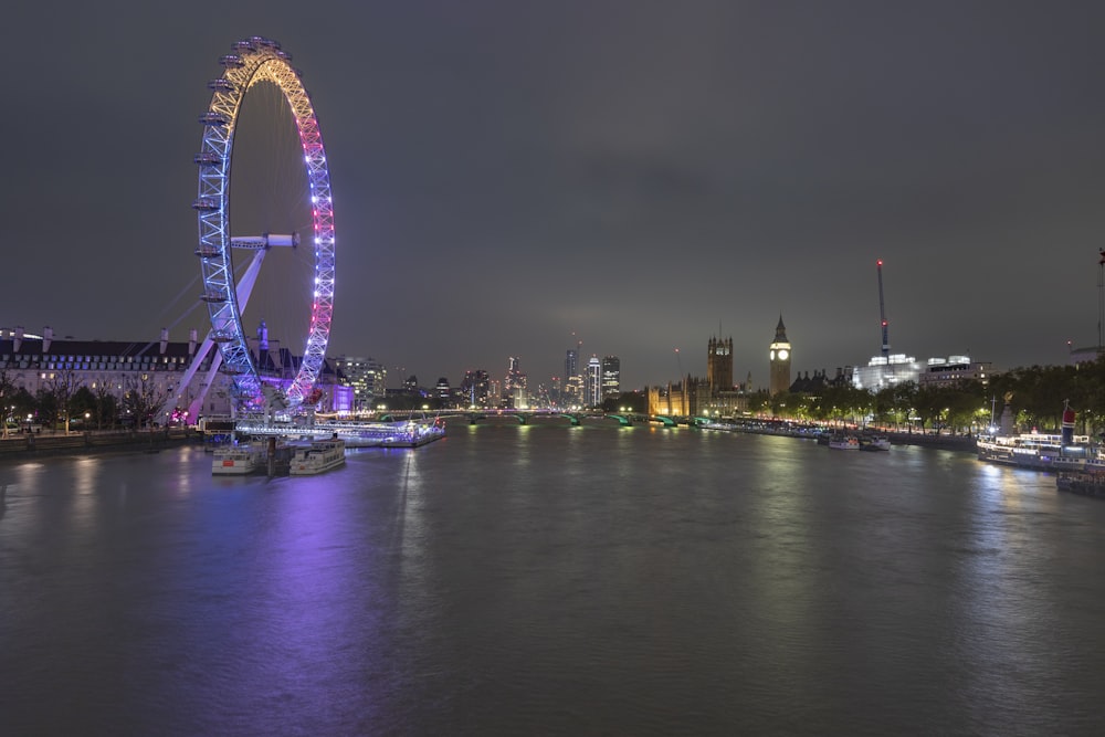 a ferris wheel lit up in the night sky