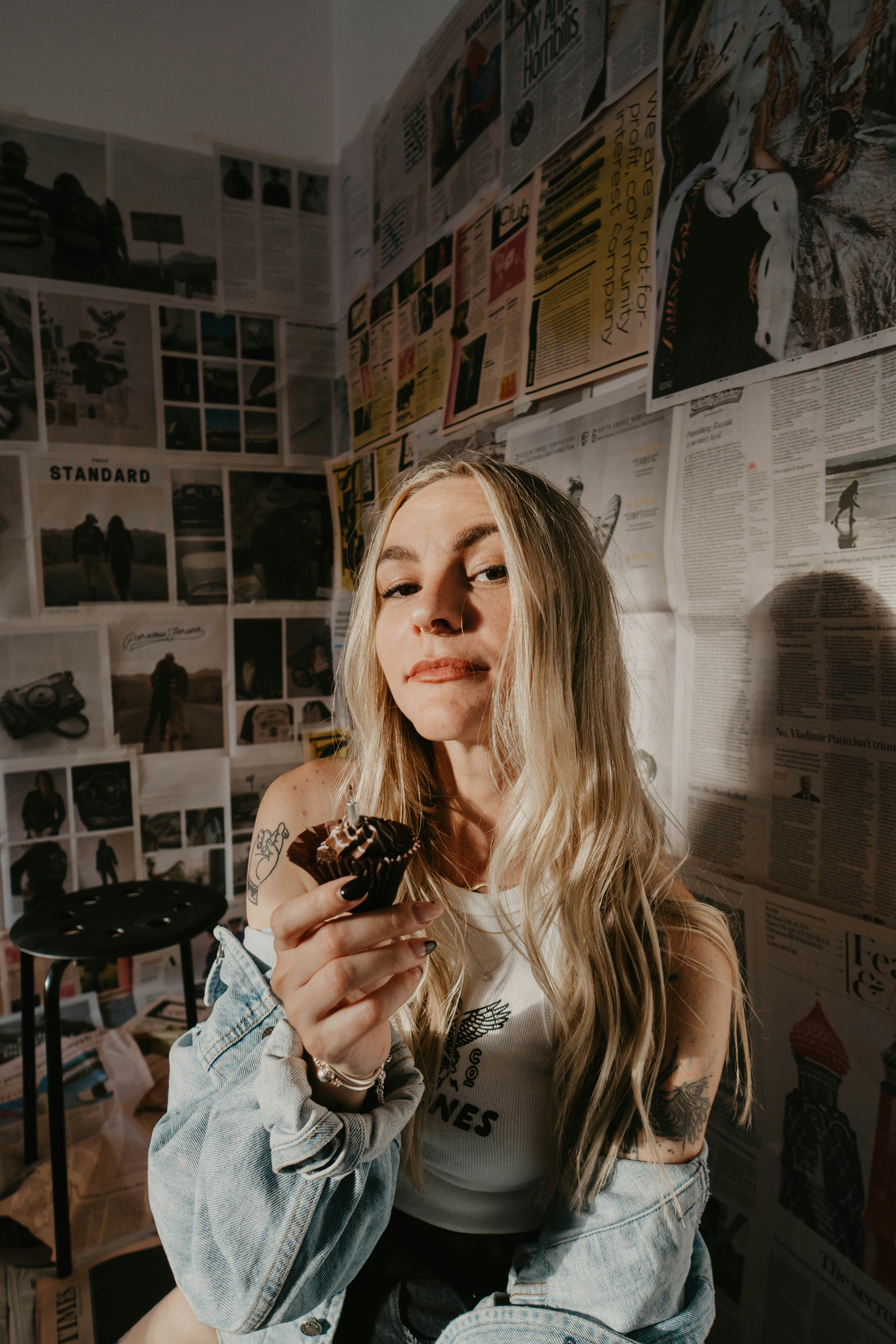 a woman sitting on a chair eating a donut