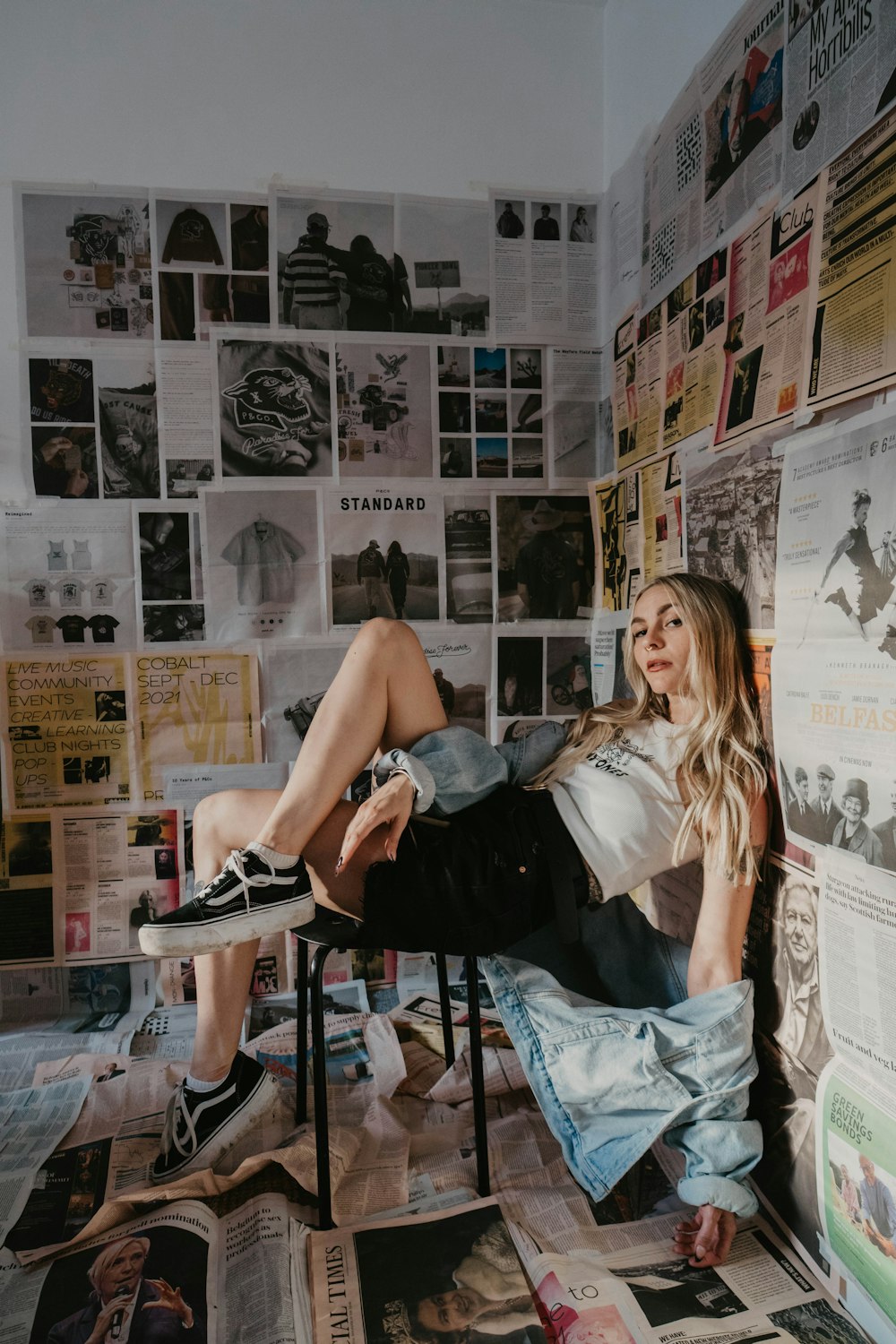 a woman sitting on top of a chair in a room