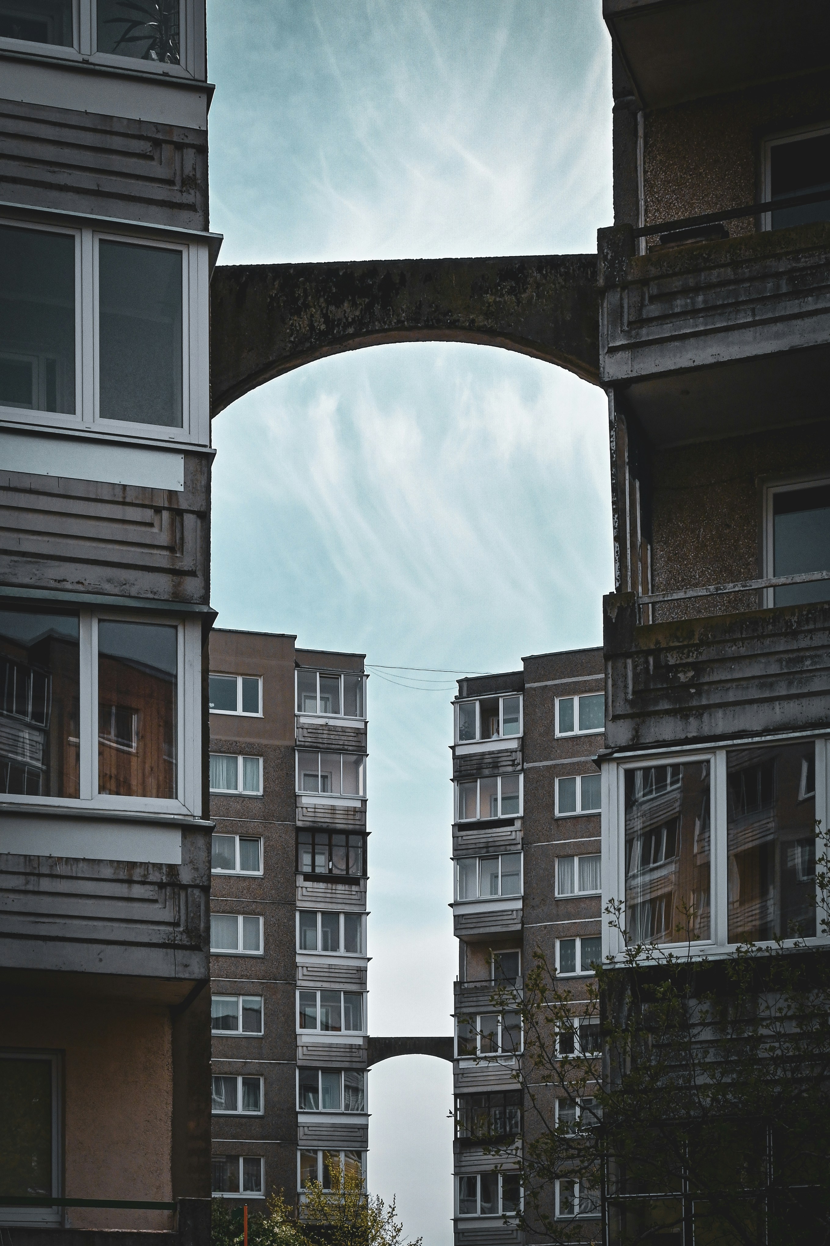 an arch in the middle of two buildings