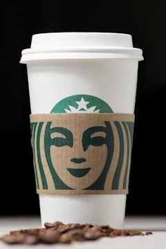 Logo design featuring a stylized coffee cup with warm earth tones.