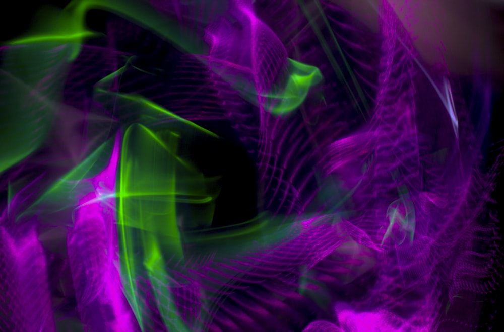 a purple and green abstract background with a black background
