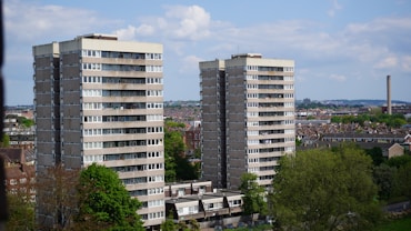 a couple of tall buildings sitting next to each other