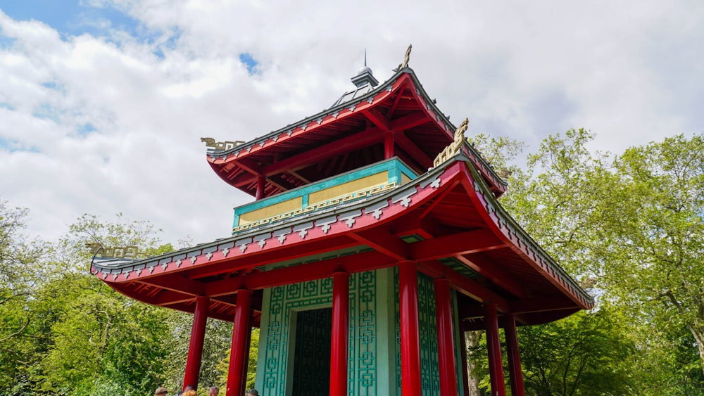 a red and green building with a sky background