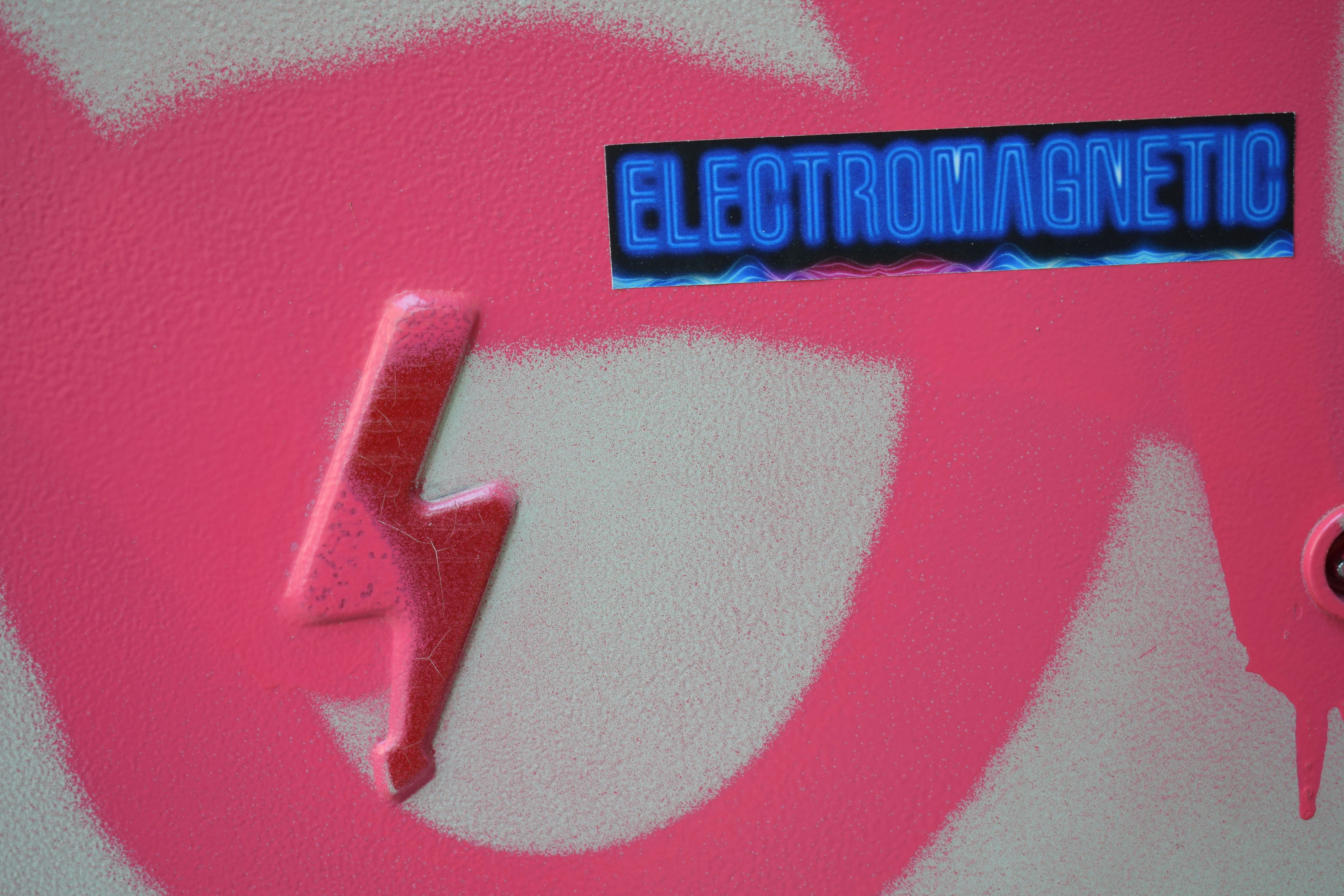 a close up of a sticker on a pink skateboard