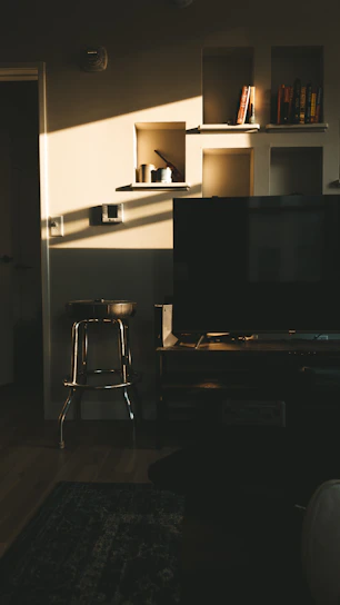 A cozy family living room with smart lighting and organized shelves.
