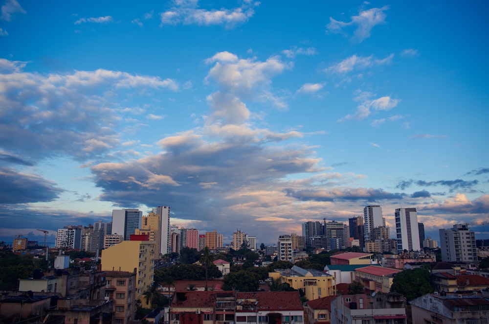 a view of a city with tall buildings under a cloudy sky