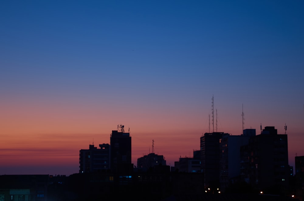 a view of a city skyline at sunset