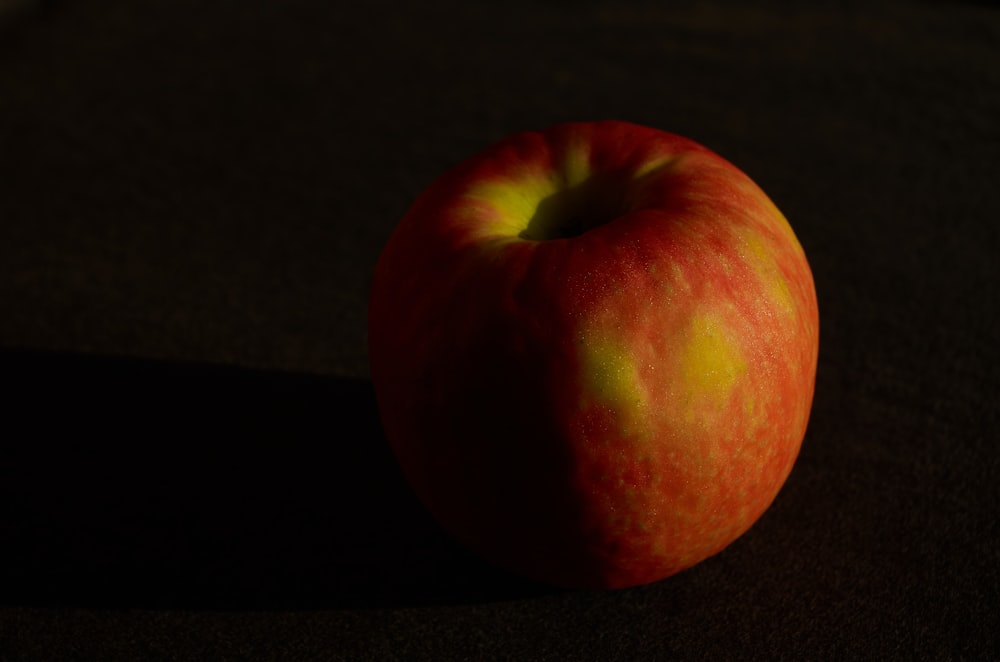 a red apple sitting on top of a table