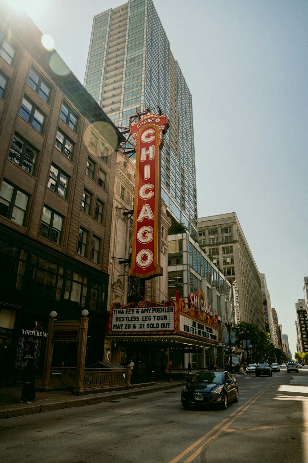 a city street with a large sign on the side of it