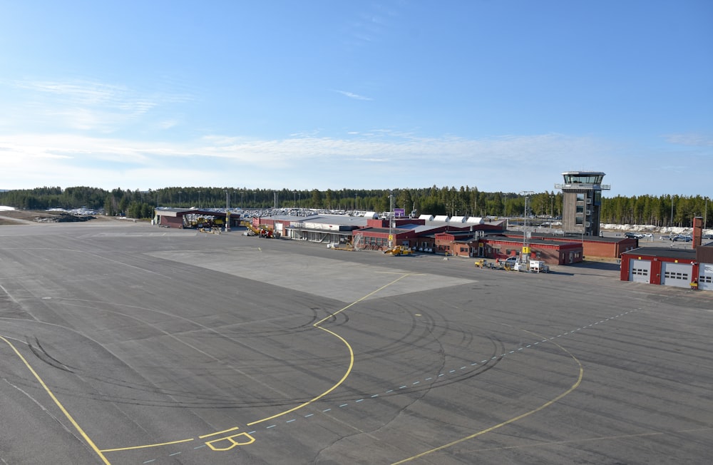 an airport tarmac with a plane parked on it