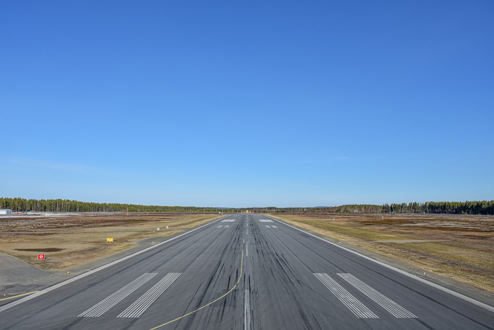 an airport runway with a clear blue sky