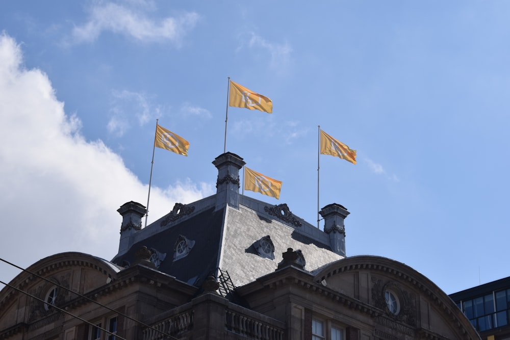 a building with three flags on top of it