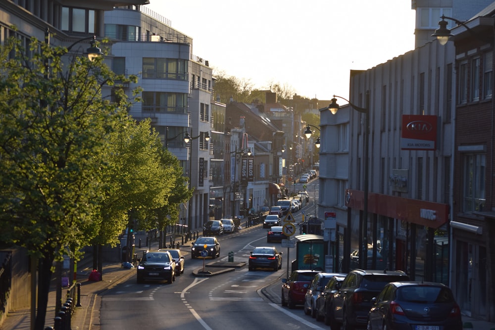 a city street filled with lots of traffic next to tall buildings