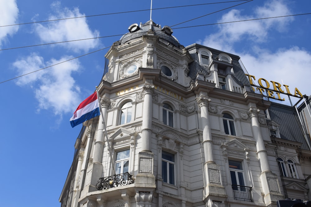 a tall building with a flag on top of it