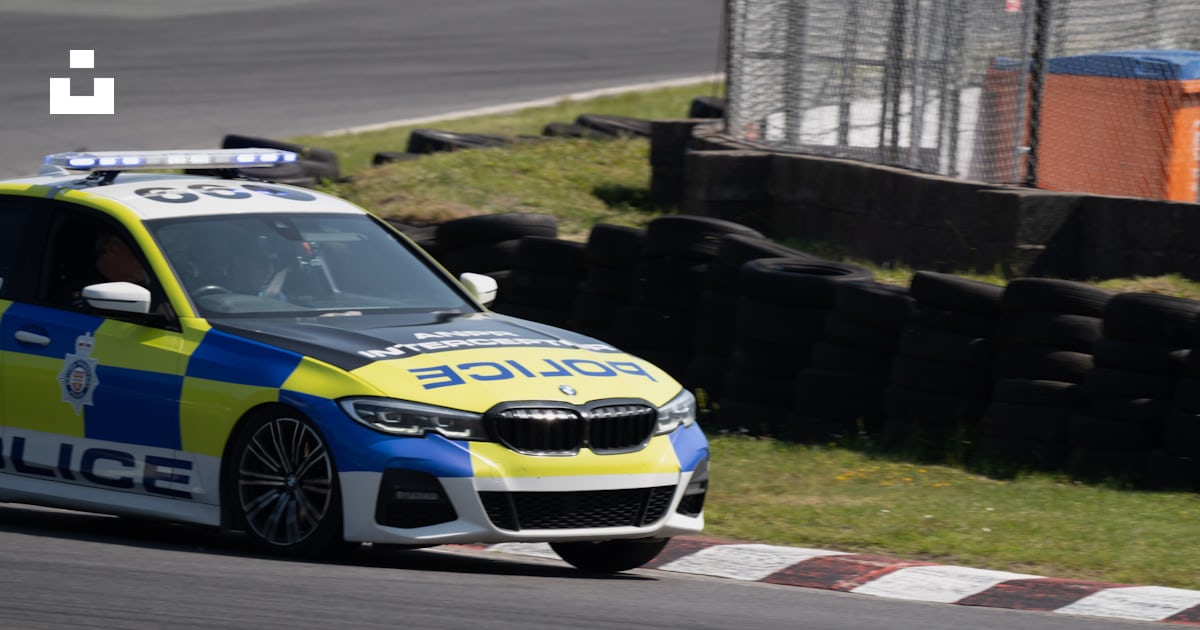 A police car driving down a race track photo – Free Uk Image on Unsplash