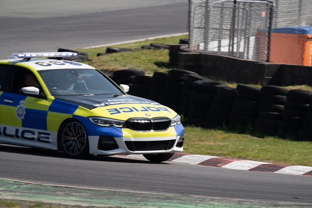 a police car driving down a race track