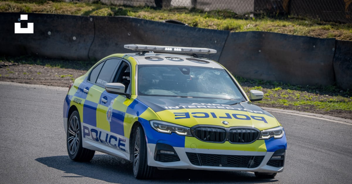 A police car driving down a race track photo – Free Uk Image on Unsplash