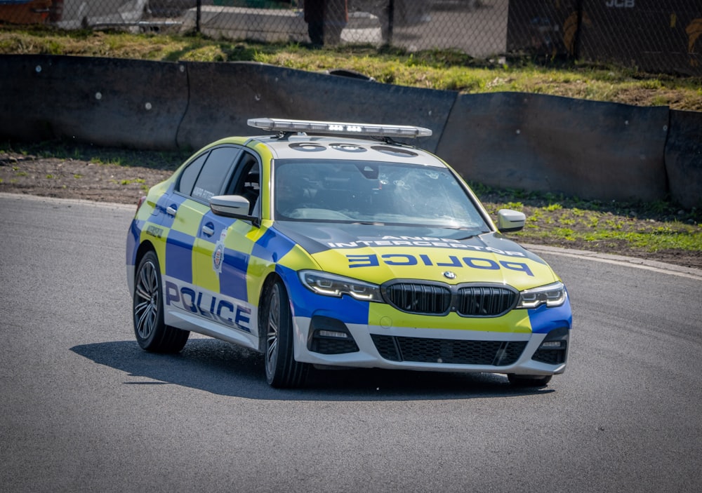 a police car driving down a race track