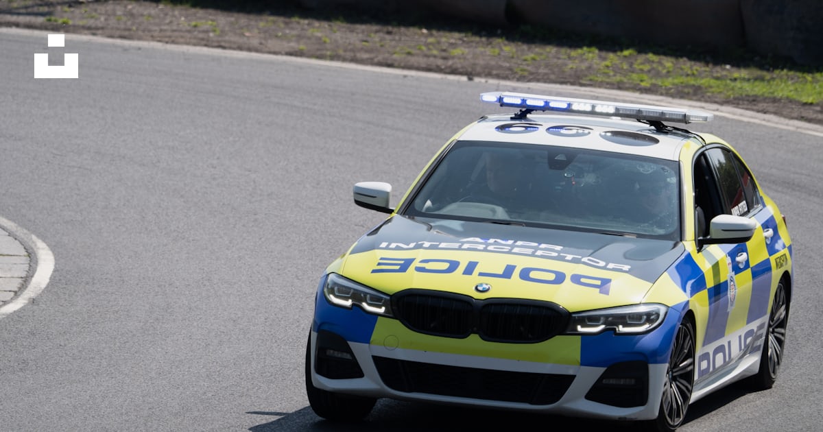 A police car driving down a race track photo – Free Ashton-in ...