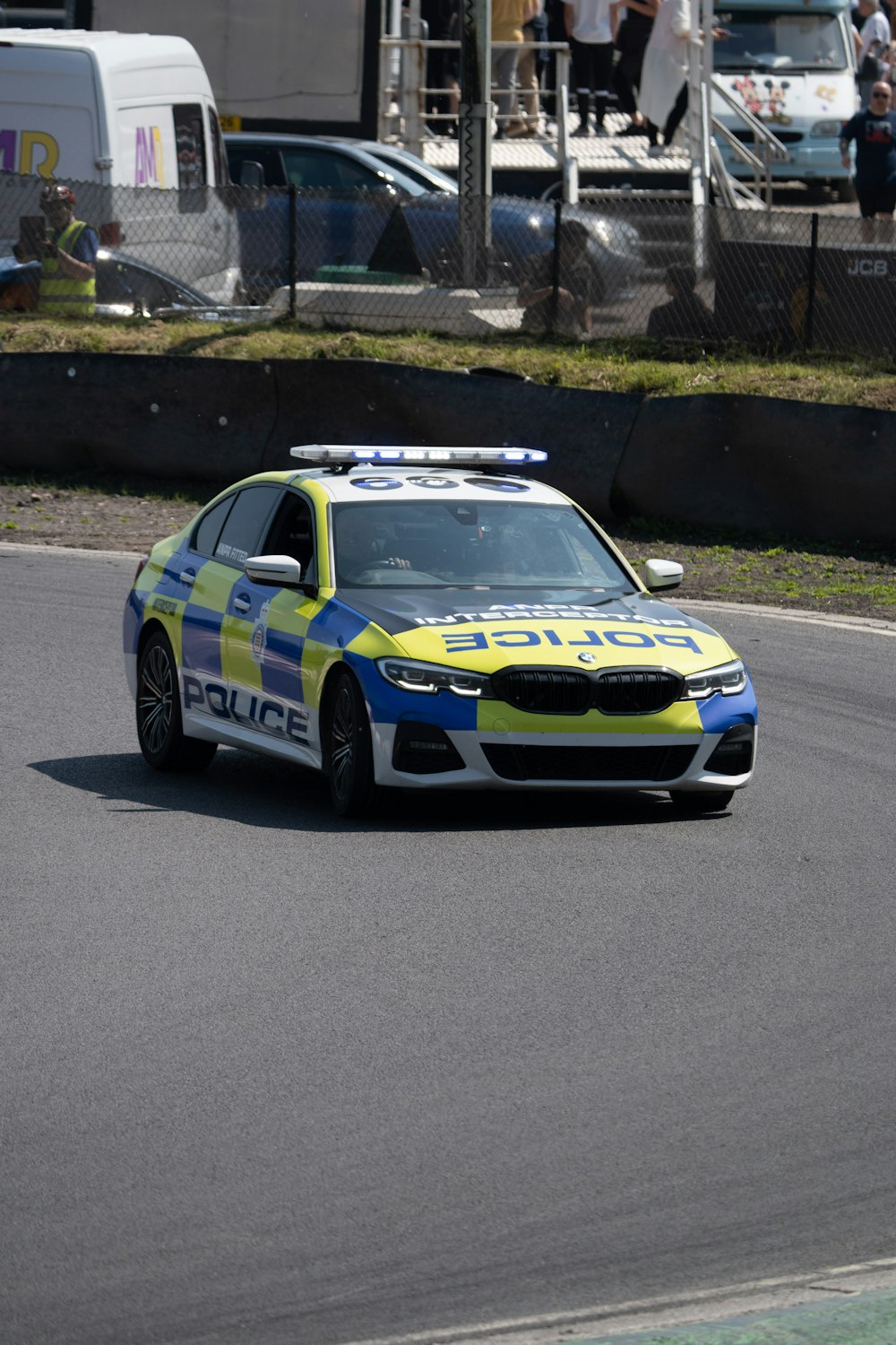 a police car driving down a race track