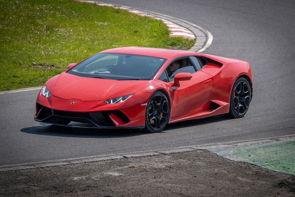 a red sports car driving on a race track