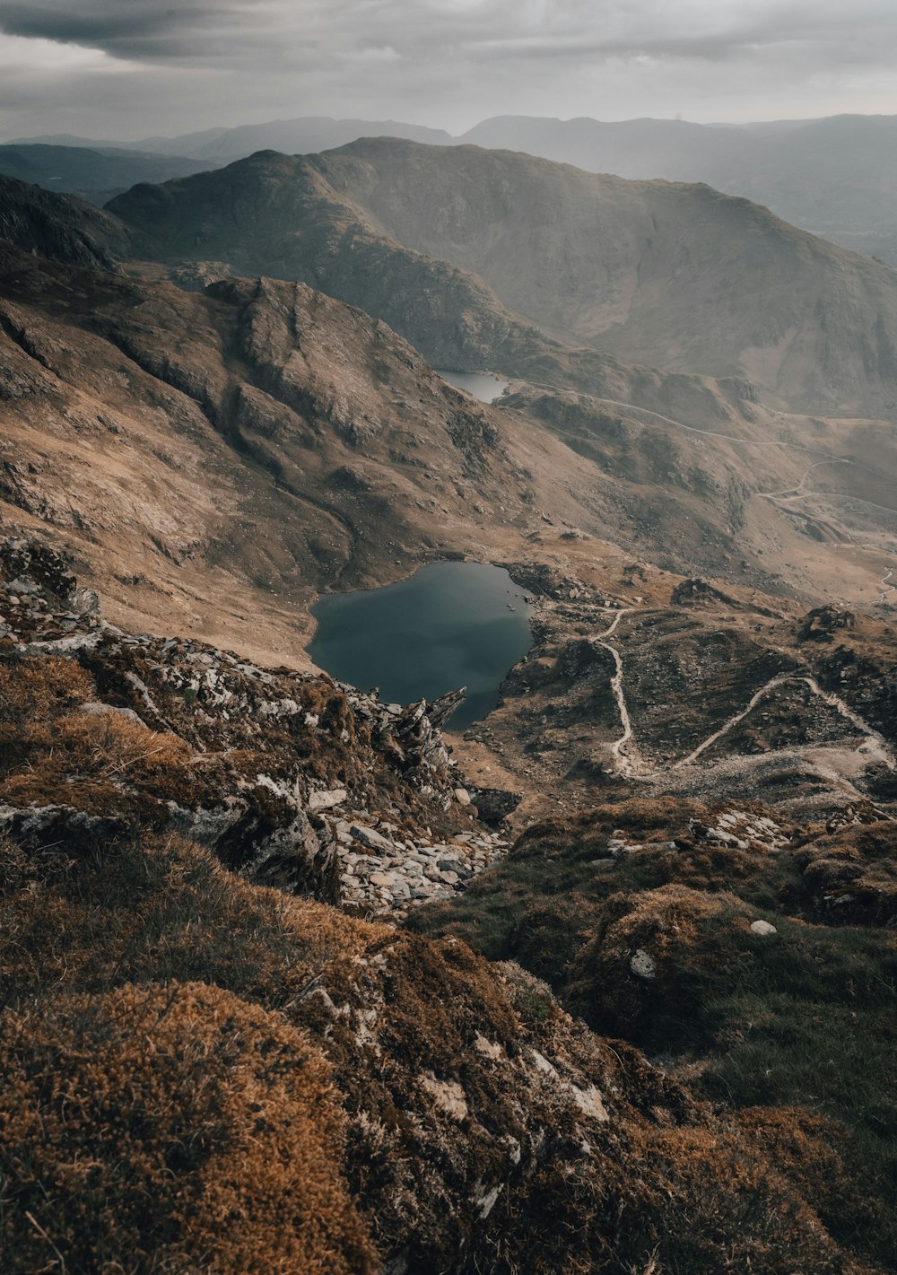 a view of a mountain range with a lake in the middle