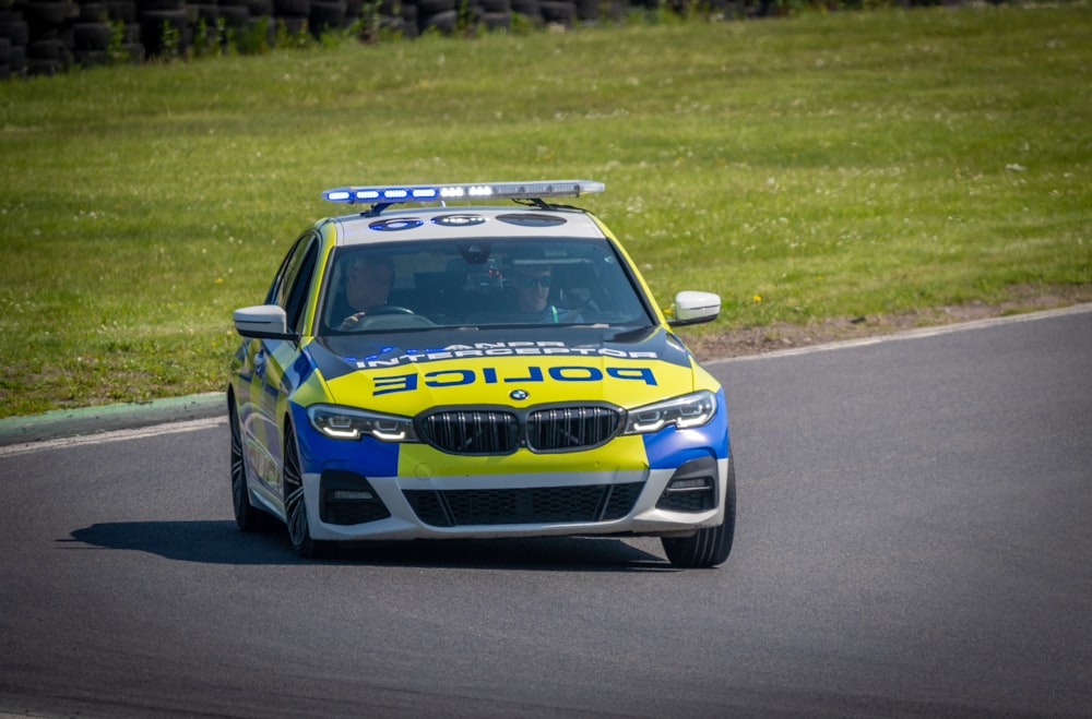 a police car driving down a race track