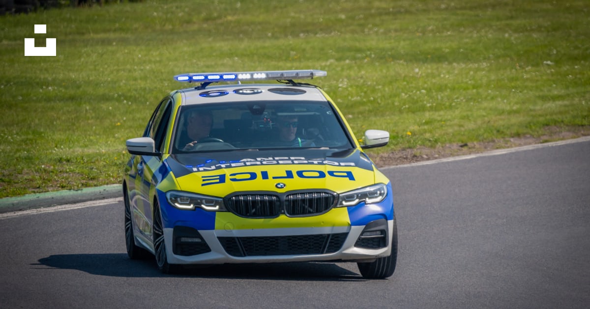 A police car driving down a race track photo – Free Uk Image on Unsplash