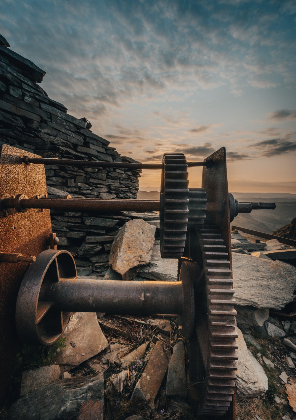 a large metal object sitting on top of a pile of rocks