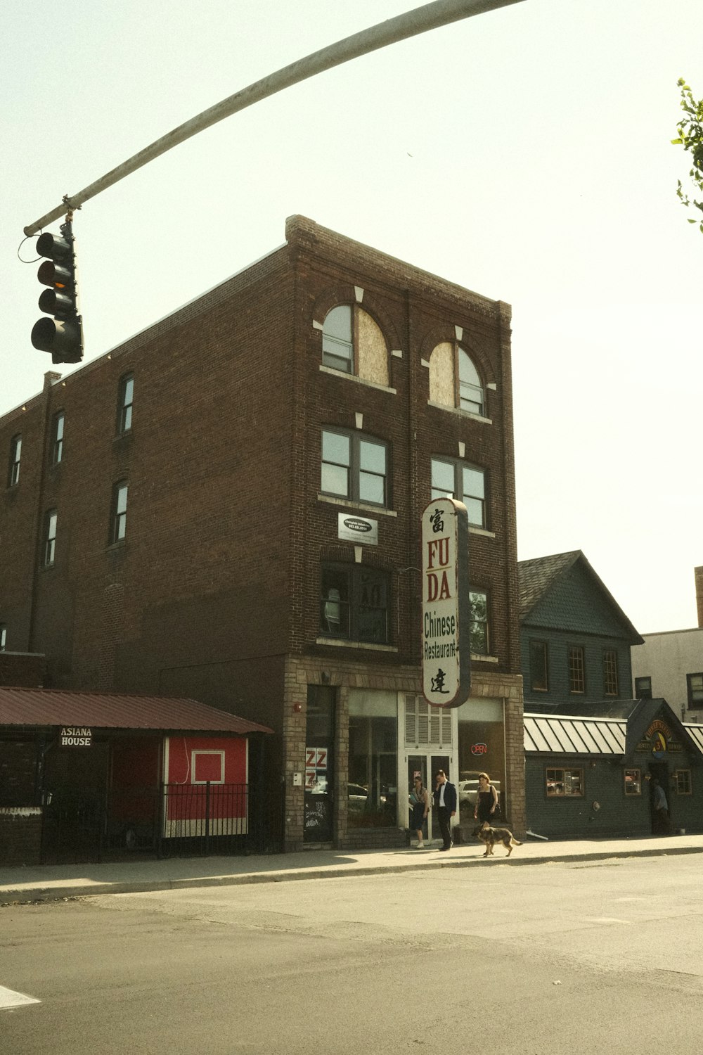 a tall brick building sitting on the corner of a street