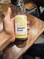 Close-up of a rustic fermentation jar with bubbling kombucha, set against a vintage wooden table.