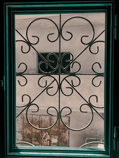 Steel gates and grills displayed in a workshop setting.